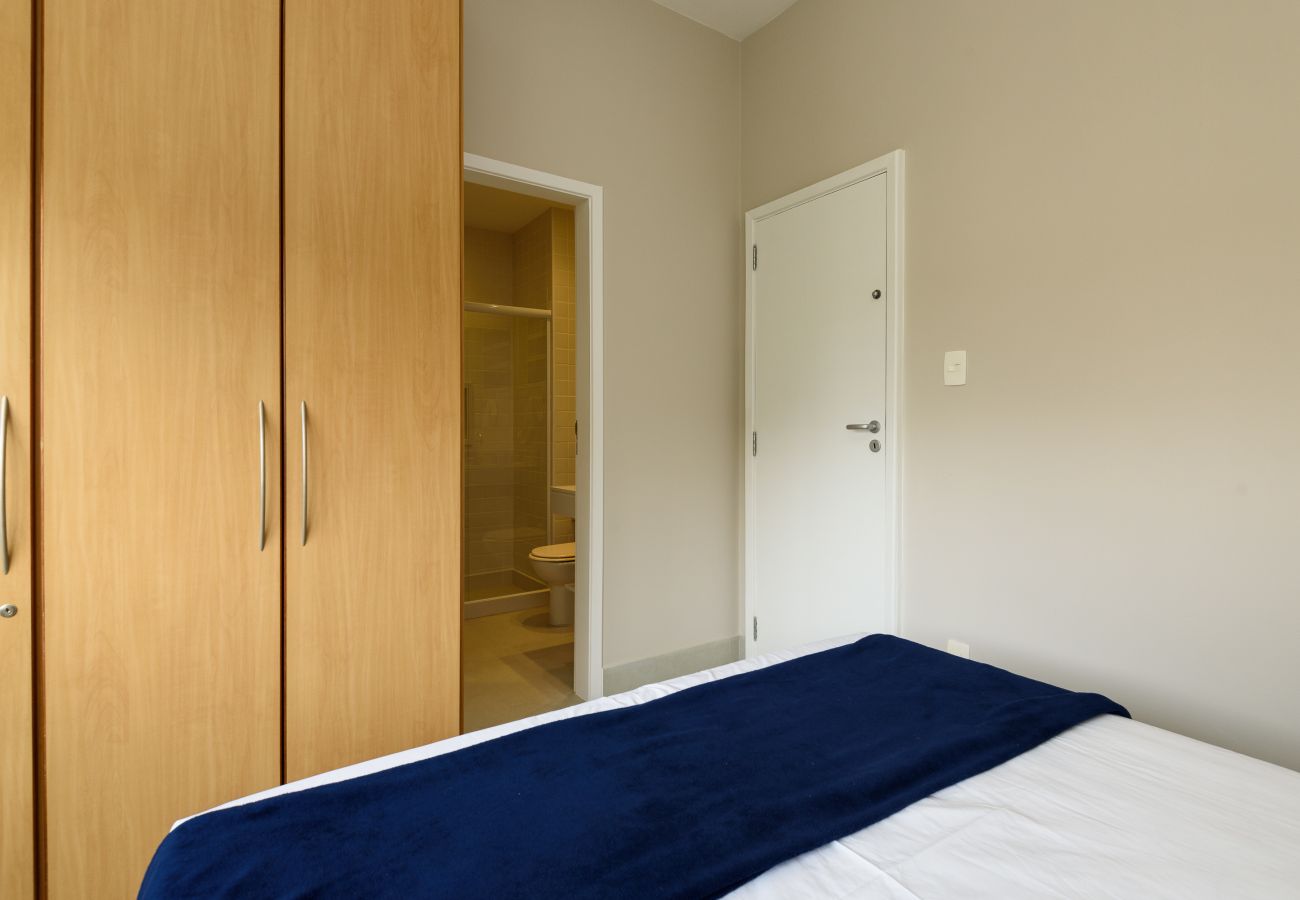 Bedroom with double bed, wardrobe and bed linen.