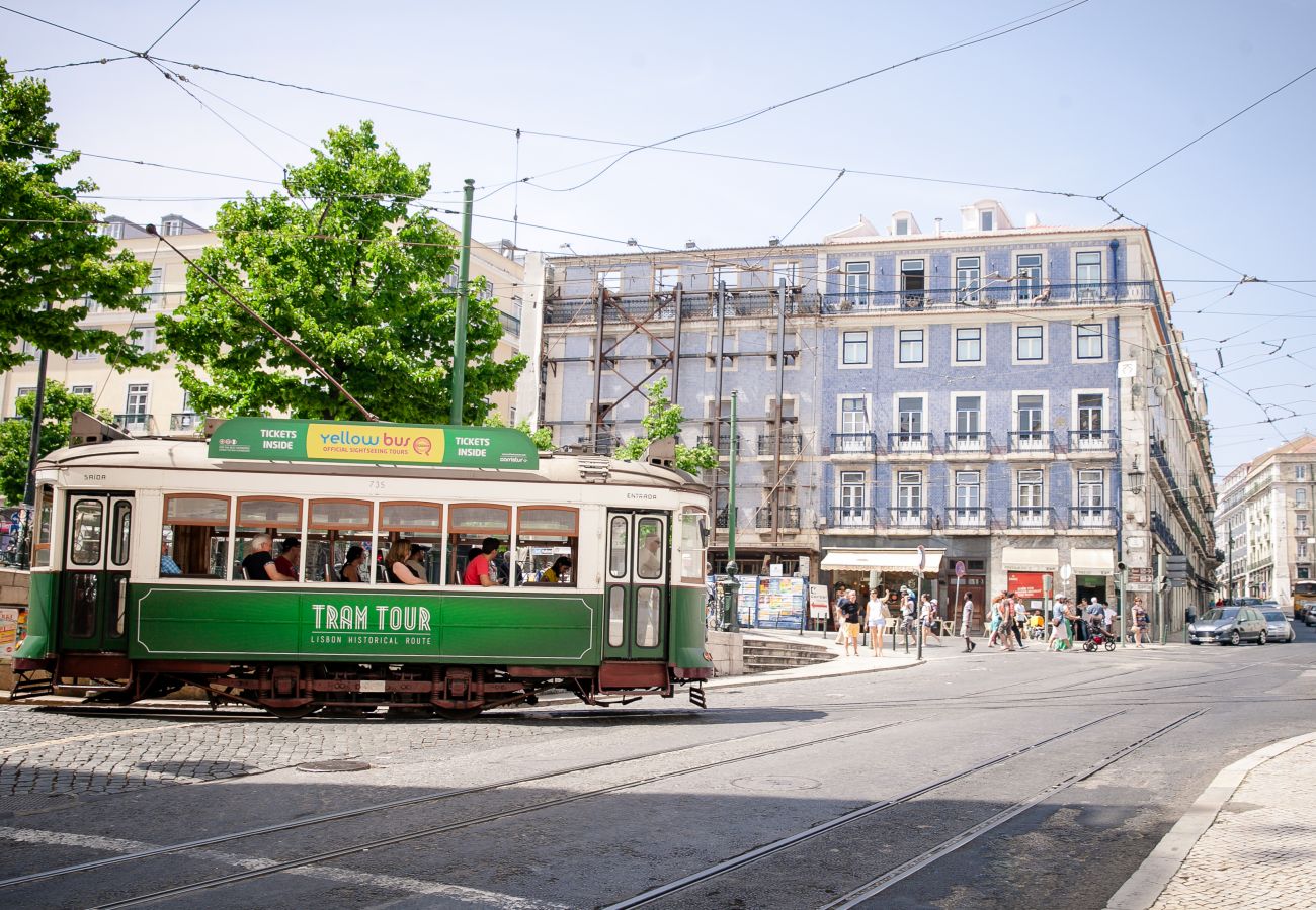 Grande place à Lisbonne avec un tram typique de la capital portugaise.